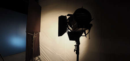 Studio light equipments for photo or film movie video. Light set for professional shooting and screen background. LED Flood light and Spot light for video production. Setup include Barn door softbox.の写真素材