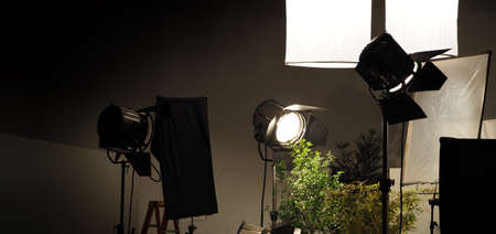 Studio light equipments for photo or film movie video. Light set for professional shooting and screen background. LED Flood light and Spot light for video production. Setup include Barn door softbox.の写真素材