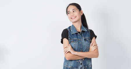 Asian Young woman gesture posing on white background. represent cheerful and confident. Showing gestures such as mini heart Okay Thumb up or point out. Happy amazed excited and surprised Jacket jeans.の写真素材
