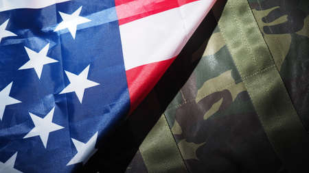 American flag and Military hat or bag. Top view angle. Soldier hat or helmet with national american...