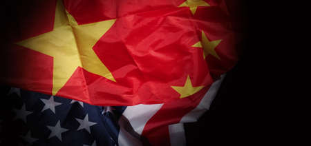 USA and China flag on black background. Represent serious trade tension or trade war between America and China. financial concept. Flags of China and the United States of America on Black. top view angle.の写真素材