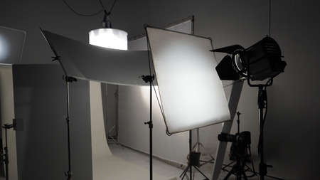 Studio light equipments for photo or film movie video. Light set for professional shooting studio background. LED Flood light and Spot light for video production studio. Setup include Barn door softbox.の写真素材