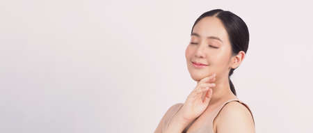 Beauty and skin concept. Young asian woman beauty face make up for skincare cosmetic and showing natural wellness soft and firm and ageless facial skin. younger looking youthful. real acne no retouch.の写真素材