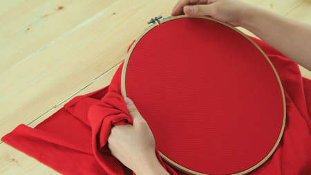 Woman hands and craft work. Embroider sewing by hand. Handicraft work by thread needle sew knit. Wood frame embroidery hoop. Needlework handicraft crafting quarantine leisure concept.の写真素材