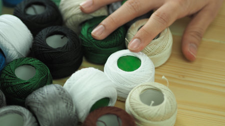 Embroider sewing by woman hand. Craft work and female hands. Handicraft work by thread needle sew...