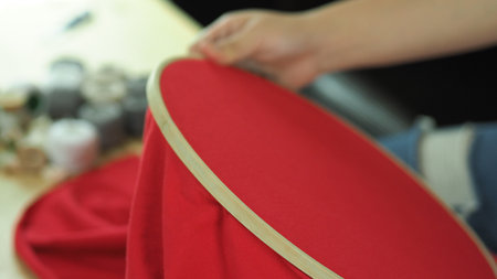 Embroider sewing by woman hand. Craft work and female hands. Handicraft work by thread needle sew knit. Wood frame embroidery hoop. Needlework handicraft crafting quarantine leisure concept.の写真素材