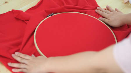 Embroider sewing by woman hand. Craft work and female hands. Handicraft work by thread needle sew...