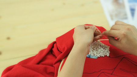 Embroider sewing by woman hand. Craft work and female hands. Handicraft work by thread needle sew...