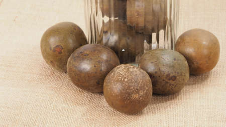 Monk fruit or Luo Han Guo. Dried fruits for healthy sweetener drink. Natural herbal remedy and glass...
