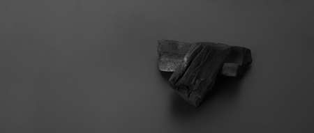 Wood charcoal. Black Charcoal on black textured floor. Used for cooking grill or other industries. Natural wood charcoal. Black carbon reesidue produced by strongly heating wood. for traditional BBQの写真素材