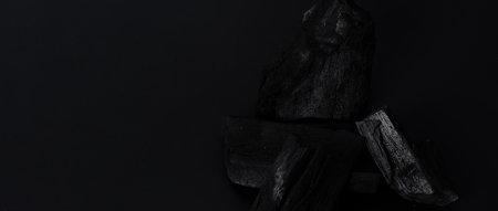 Wood charcoal. Black Charcoal on black textured floor. Used for cooking grill or other industries. Natural wood charcoal. Black carbon reesidue produced by strongly heating wood. for traditional BBQの写真素材