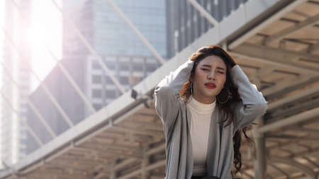 Lay off. Sacked. Fired business woman sitting on stairs of office building outside. Depressed young business woman unemployment due to coronavirus crisis. worry no job no money. Laid off got fired.の写真素材