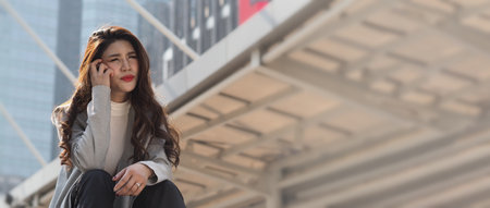 Lay off. Sacked. Fired business woman sitting on stairs of office building outside. Depressed young business woman unemployment due to coronavirus crisis. worry no job no money. Laid off got fired.の写真素材