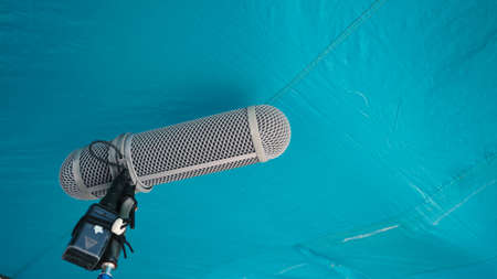 Microphone boom type. Sound recorder boom mic and tripod stand. Professional digital audio recording gear mic for making film or video movie production. Wind protection on boom mic. Movie industryの写真素材