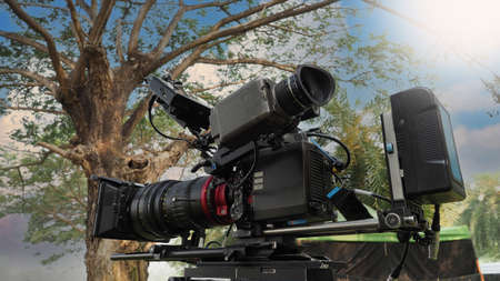 Movie Camera. Behind the video camera that for recording film commercial or movie at outdoor...