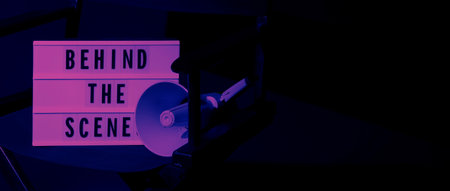 Director chair with behind the scene banner light box. Letterboard text Lightbox or Cinema Light box. Movie clapperboard and Director chair. Black Background. Represent video behind the scenes is on.の写真素材