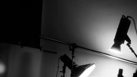 Blurry images of Studio light equipment for filming movie video or professional photo shooting. Shot on monitor screen reflects. Lights studio on tripod for video recording. Soft focus blur images.の写真素材