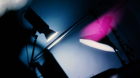Blurry images of Studio light equipment for filming movie video or professional photo shooting. Shot on monitor screen reflects. Lights studio on tripod for video recording. Soft focus blur images.の写真素材