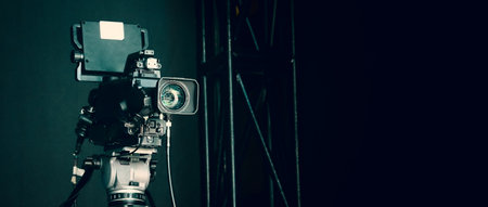 TV Camera broadcast on the crane tripod for shooting or recording and broadcasting content in studio production to on air tv or online internet live show. HD Video recording on crane. Selective focus.の写真素材