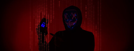 Digital security Concept. Anonymous hacker with mask holding smartphone hacked. Personal and Cyber...