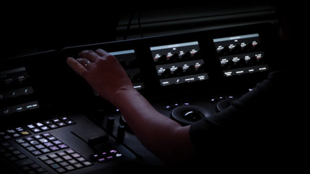 Edit video production control panel in studio. Editor editing and grade film in movie post room. Telecine control machine and man hand editing or adjusting color on digital video in post production.の写真素材