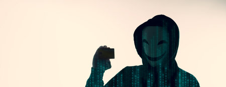Hacker man and credit cards in hand. Represent credit cards personal data stolen by anonymous man in...