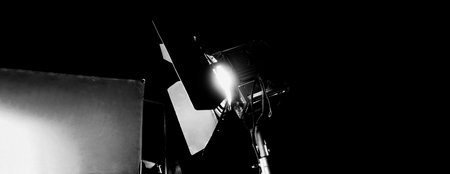 Film light for video production camera in studio set. Use as studio photo shoot light. Big LED spot light 5000w and diffuser or black panel create light like sun light can make daytime or golden hourの写真素材