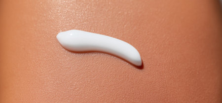 Close up of Sunscreen Protection or Sun Cream on human skin. Skin and Body Care. SPF Lotion or Moisturizing Sunblock to protect skin from the sun UV Sun screen cosmetic cream texture skincare productの素材