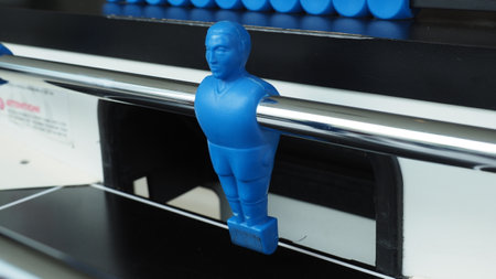 Football table or soccer table game with plastic player figurine. Mini Soccer game which famous in past and be collectable item for foosball lover. Play by two hand control each row of player figurineの写真素材