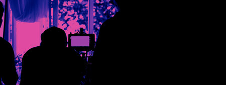 Behind the scenes of video shooting production crew team silhouette and camera equipment in studio.