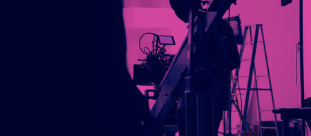 Filmmaker crew team with professional cinema equipment and video camera on the set. Film director...