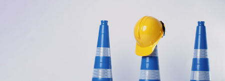 Road traffic safety equipment. Realistic blue traffic cones and yellow safety helmet isolated on white background. Roadside tools for road work or unpredicted automotive accident. Safety first conceptの写真素材