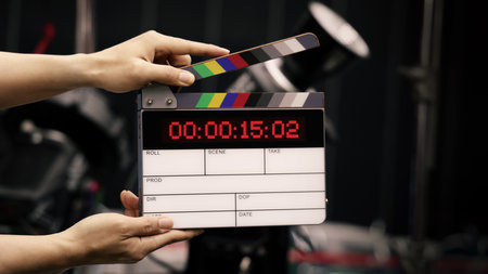 Digital film slate for filmmaker in set. Hand hitting timecode clapperboard or movie slate for Video...