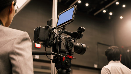 Professional cinema cameras being used in a studio or event setting.  High end gear with crew operation and behind the scenes video production in action. Camera for Live recording and broadcasting.の写真素材