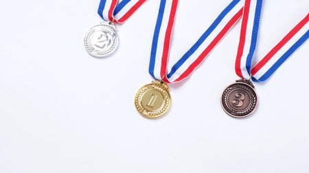 Gold silver and bronze demonstration trophy medals with ribbon for school university or national or olympic sport even organization competition. Isolated on white background. Award and victory conceptの写真素材