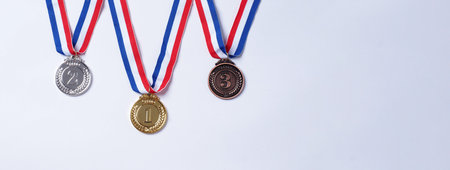 Gold silver and bronze demonstration trophy medals with ribbon for school university or national or olympic sport even organization competition. Isolated on white background. Award and victory conceptの写真素材