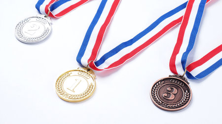 Gold silver and bronze demonstration trophy medals with ribbon for school university or national or olympic sport even organization competition. Isolated on white background. Award and victory conceptの写真素材