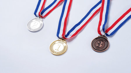 Gold silver and bronze demonstration trophy medals with ribbon for school university or national or olympic sport even organization competition. Isolated on white background. Award and victory conceptの写真素材