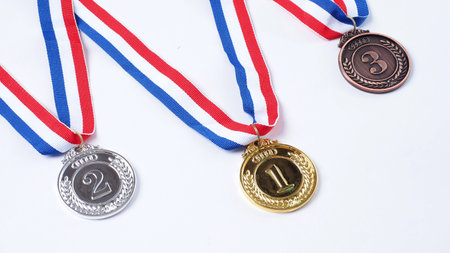 Gold silver and bronze demonstration trophy medals with ribbon for school university or national or olympic sport even organization competition. Isolated on white background. Award and victory conceptの写真素材