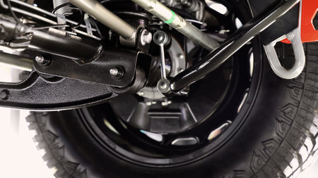 Car suspension part. Close up of a rear car suspension and exhaust system. such as coil springs link arms axle housing and performance exhaust. For auto engineering or car suspension part industry useの写真素材