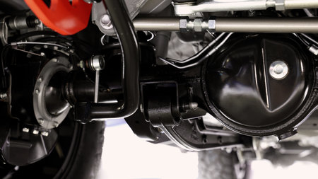 Car suspension part. Close up of a rear car suspension and exhaust system. such as coil springs link arms axle housing and performance exhaust. For auto engineering or car suspension part industry useの写真素材