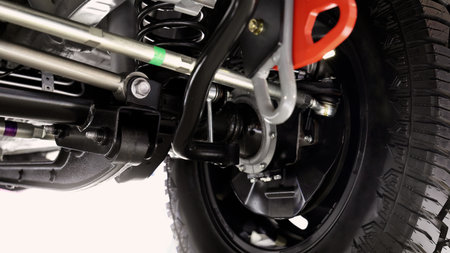 Car suspension part. Close up of a rear car suspension and exhaust system. such as coil springs link arms axle housing and performance exhaust. For auto engineering or car suspension part industry useの写真素材