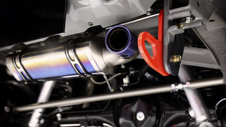 Car suspension part. Close up of a rear car suspension and exhaust system. such as coil springs link arms axle housing and performance exhaust. For auto engineering or car suspension part industry useの写真素材