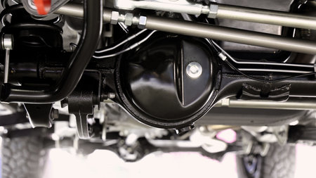 Car suspension part. Close up of a rear car suspension and exhaust system. such as coil springs link arms axle housing and performance exhaust. For auto engineering or car suspension part industry useの写真素材