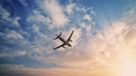 Airplane in the sky. Airplane in flight at sunset or evening sky. Commercial airliner silhouette in the colorful evening or night moon skies. Aircraft symbol of travel adventure global connectivity.の写真素材