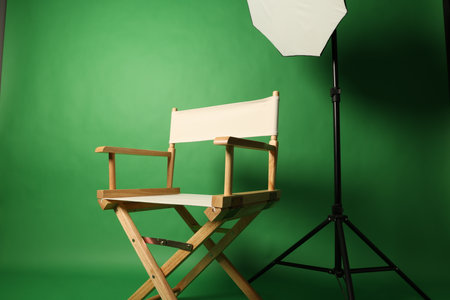 Chair of Film Director. Directors chair in green screen studio setup with softbox lighting. Ideal...