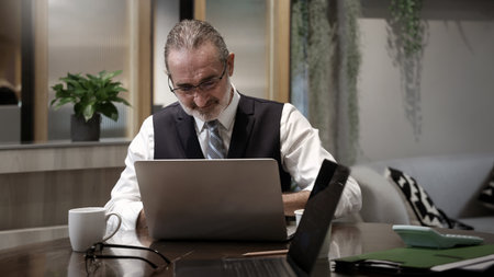 Business meeting or working in modern office. Senior executive discussing project with colleagues using laptop and online digital reports. Teamwork Leadership Strategy and Corporate Collaboration Techの写真素材