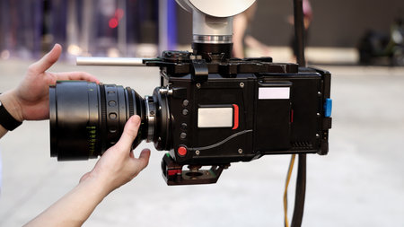 Behind the scenes of movie shooting or video production and film crew team with camera equipment at outdoor location. Video camera with professional robotic arm. BTS of Filming camera setup at outdoorの写真素材