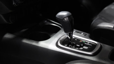 Car gear. Close up of modern car automatic gear selector or electronic shifter. Premium interior design EV car gears driving control. auto transmission modes. Automotive technology in motion driving.の写真素材