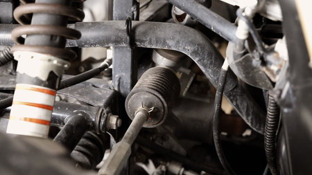 Old car suspensions. Close up car suspension wear and tear parts. CV joint Rubber boot and Control arms bushing Steering rack axles Shock absorber Brake exhaust. Gas Diesel car service repair parts.の写真素材